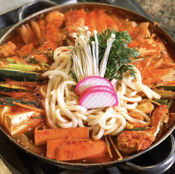 A metal pan full of noodles, vegetables and meat at Chosun Galbee in Koreatown, Los Angeles