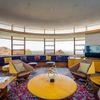 The curved window of the living room of the Norman Lykes House, with bespoke furniture