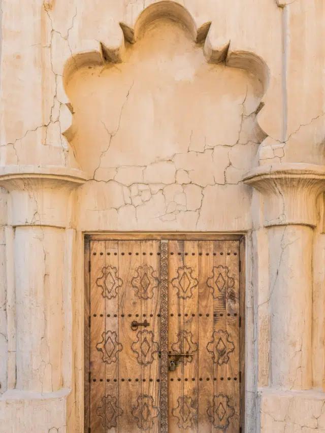 An ornate arched doorway with intricately decorative door in Dubai Creek, the city's old town