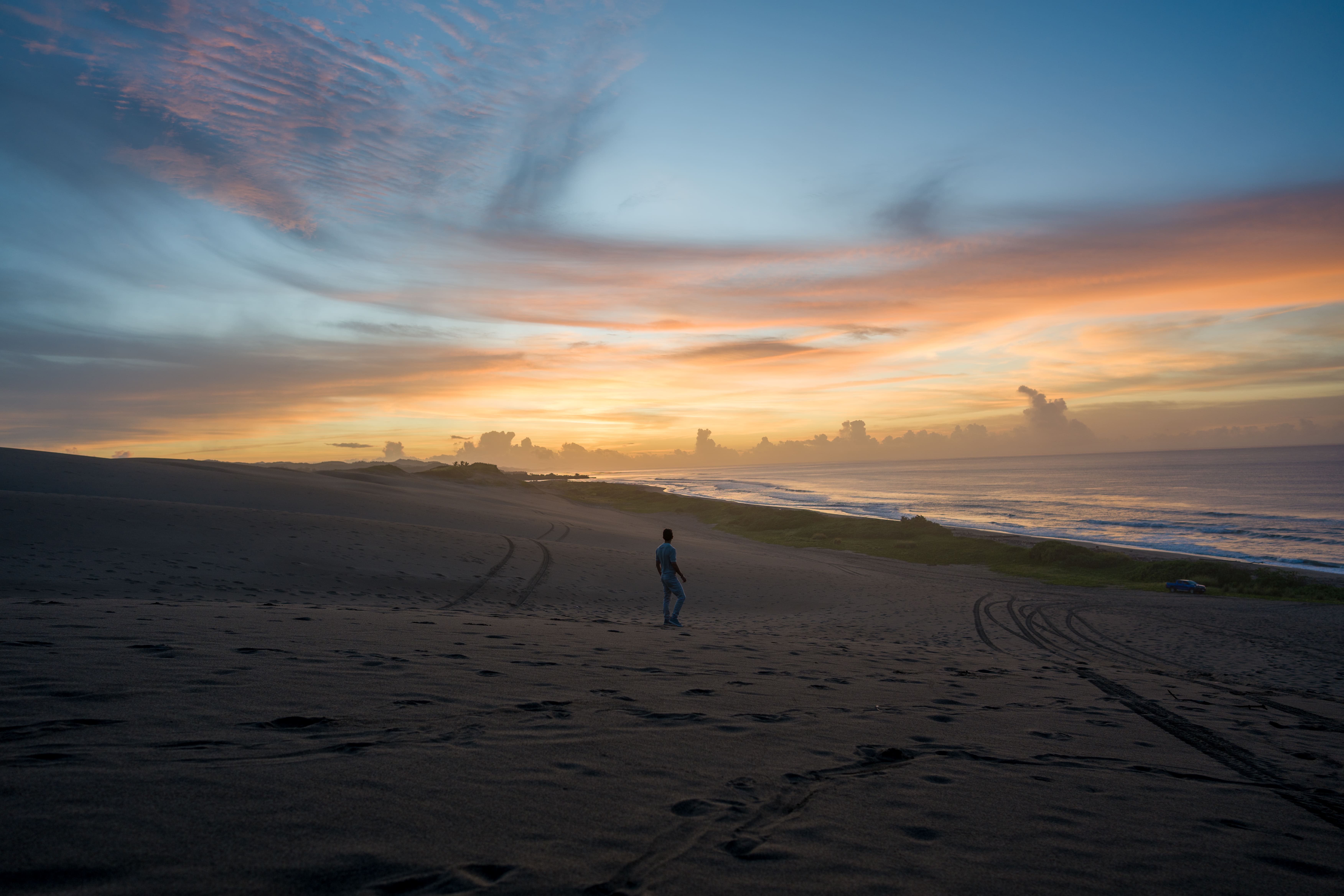 Sunrise paints the sky over Fiji’s wild dunes and empty shoreline.