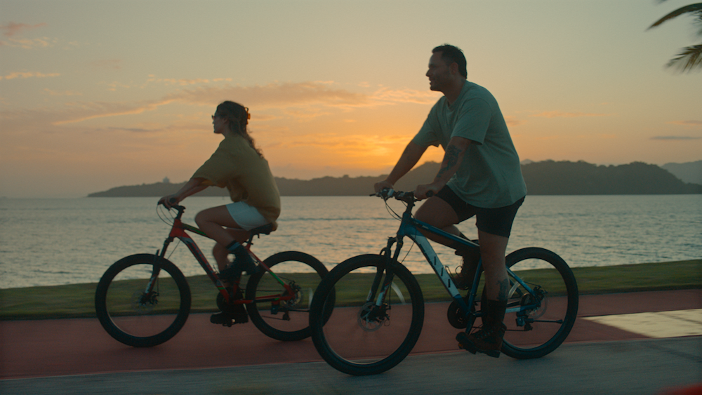 Chef José Olmedo Carles Rojas and his wife Chevy Tyler ride bikes along the Amador Causeway at sunset in Panama City