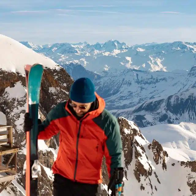 Photographer and ski guide Mathis Dumas at the top of snowy Pic Blanc in the French Alps