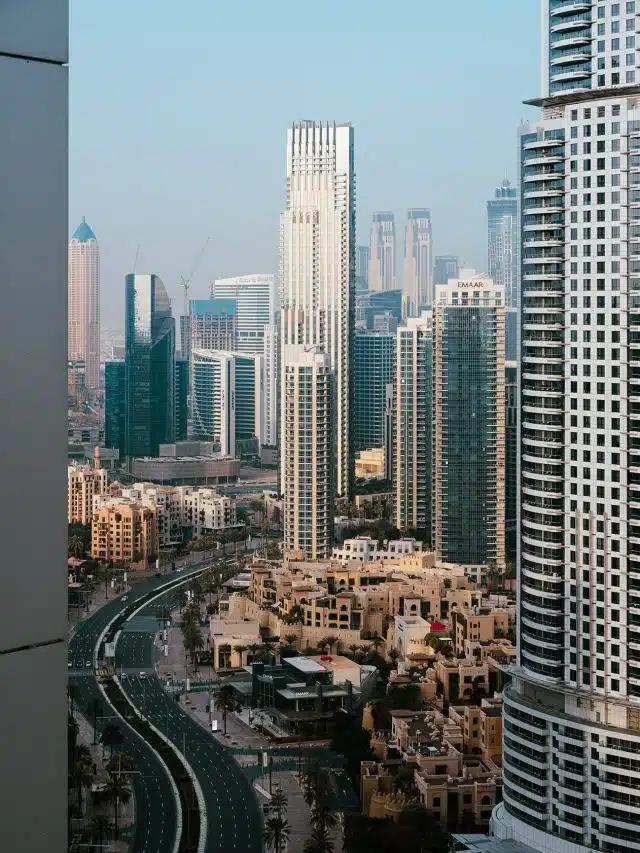 Skyscrapers sparkle in the sunlight beneath a blue sky in Downtown Dubai, United Arab Emirates
