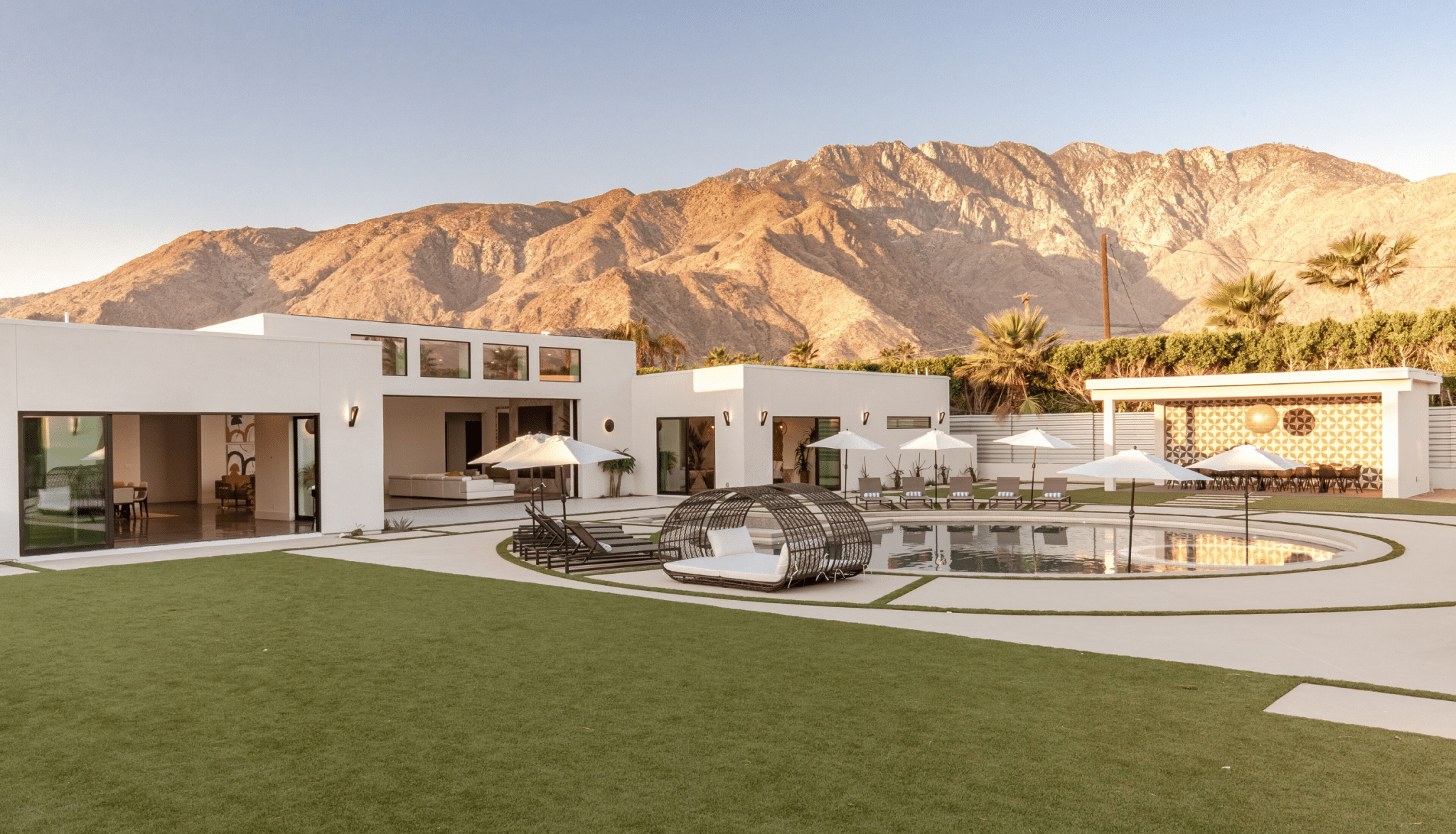 The garden of the mid-century-modern "Spahaus" Vrbo vacation rental  in Palm Springs, California, mountains seen behind in the distance