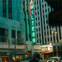 The green neon sign outside art deco venue, The Wiltern, in LA