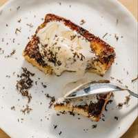 Truffle milk toast is served on a white plate at upscale “dining bar” Kumiko in Chicago, Illinois