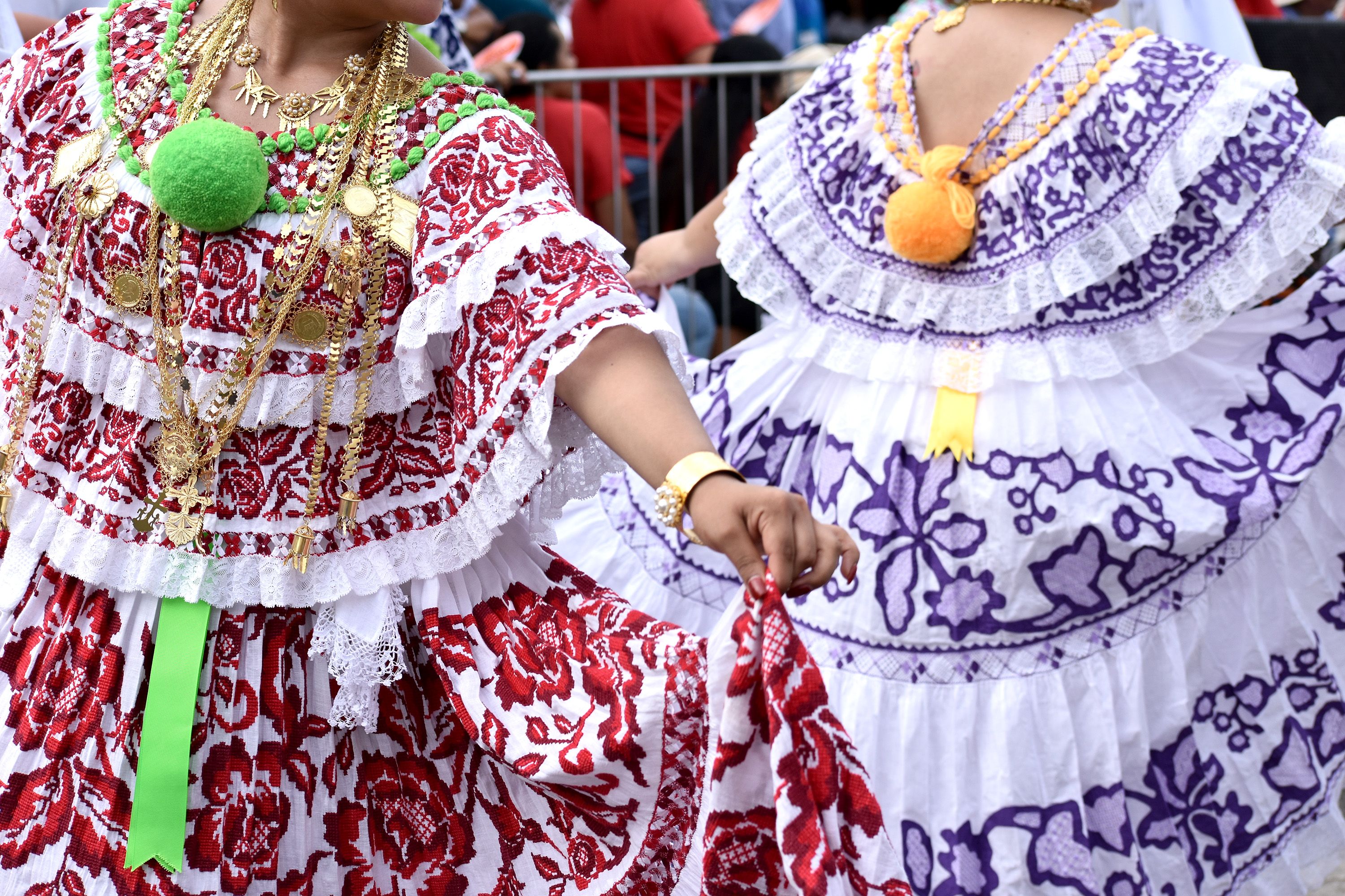Women dance in colourful Panamanian dresses.