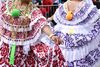 Women dance in colourful Panamanian dresses.