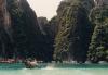 Huge tower karst jut out of the turquoise waters at Maya Bay, rising hundreds of feet above the sea