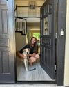 Queer Eye's Jonathan Van Ness and pet dog pictured in the open doorway of a Vrbo they rented in Las Vegas