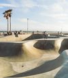 Skaters navigate the smooth curves of a skate park, Venice Beach