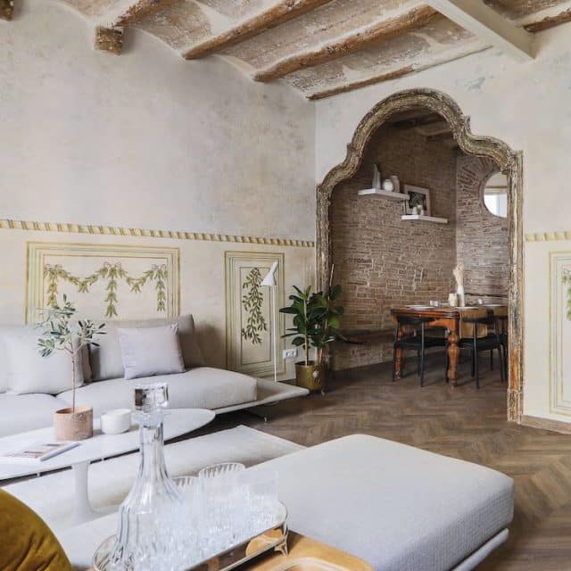 Modern comfort meets historical details such as a vaulted ceiling and ornate doorway