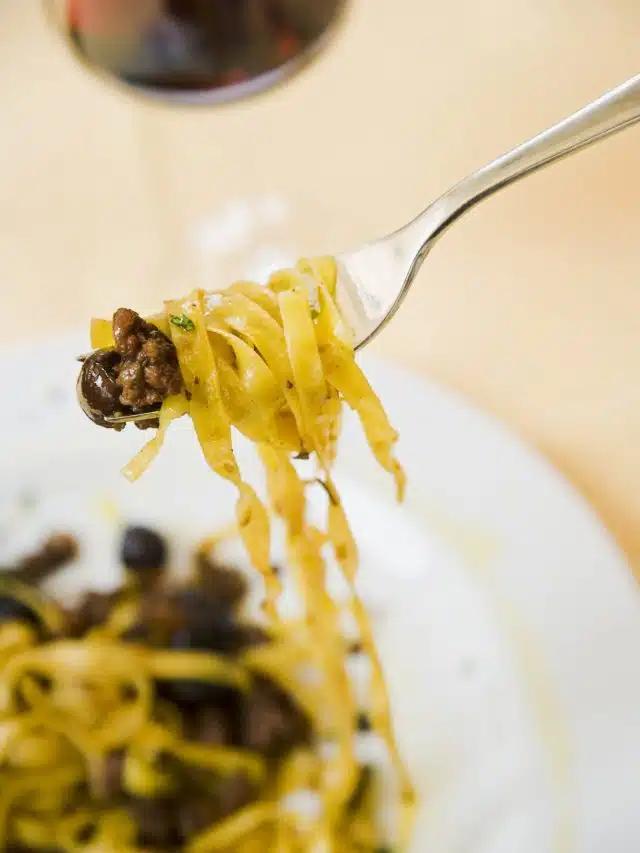 Tagliatelle and toppings on a fork at Il Guscio restaurant in Florence, Italy