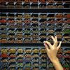 A hand selects a colored pencil from a wide array of different options at Itoya stationery store in Tokyo, Japan