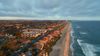 Birds-eye view of Carlsbad, California wide beach at sunseet.