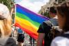 A person holds up a rainbow flag during a Pride parade