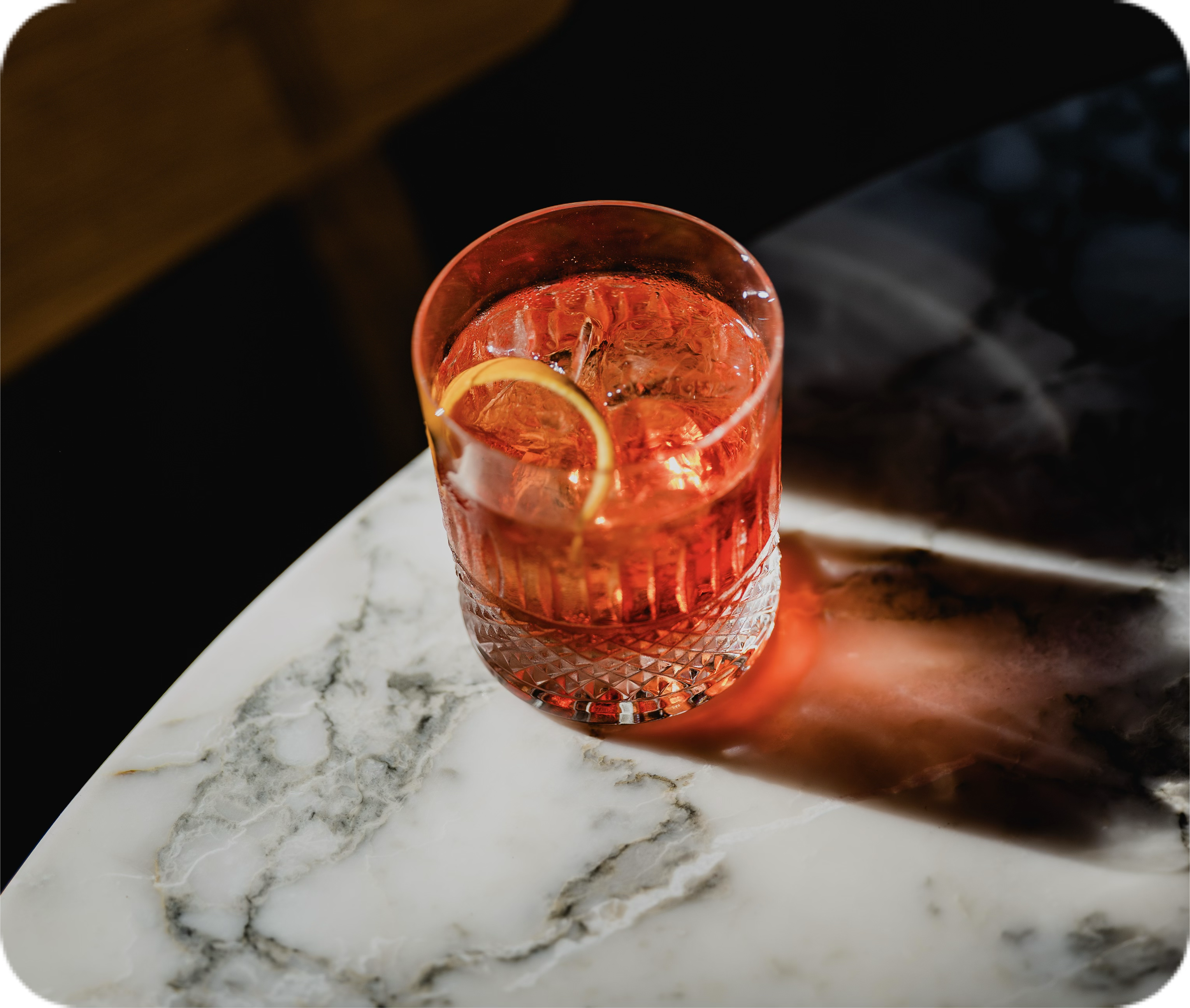 A negroni cocktail on a marble table