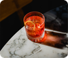 A negroni cocktail on a marble table
