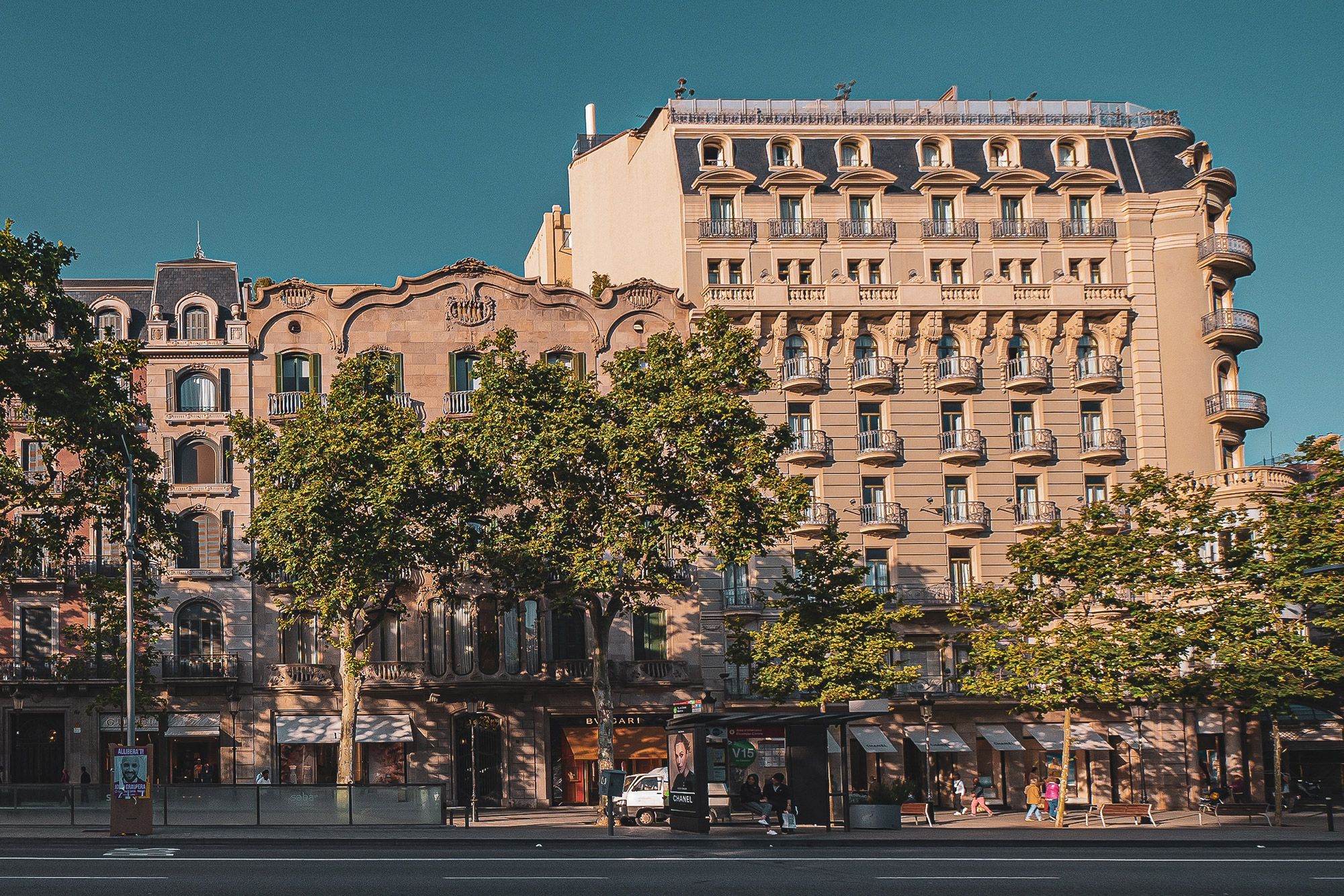 A view of the architecture and tree lined street of Passeig de Gràcia in Barcelona.