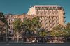 A view of the architecture and tree lined street of Passeig de Gràcia in Barcelona.