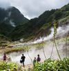 Travelers visible through the mist at the Valley of Desolation to the Boiling Lake, Dominica