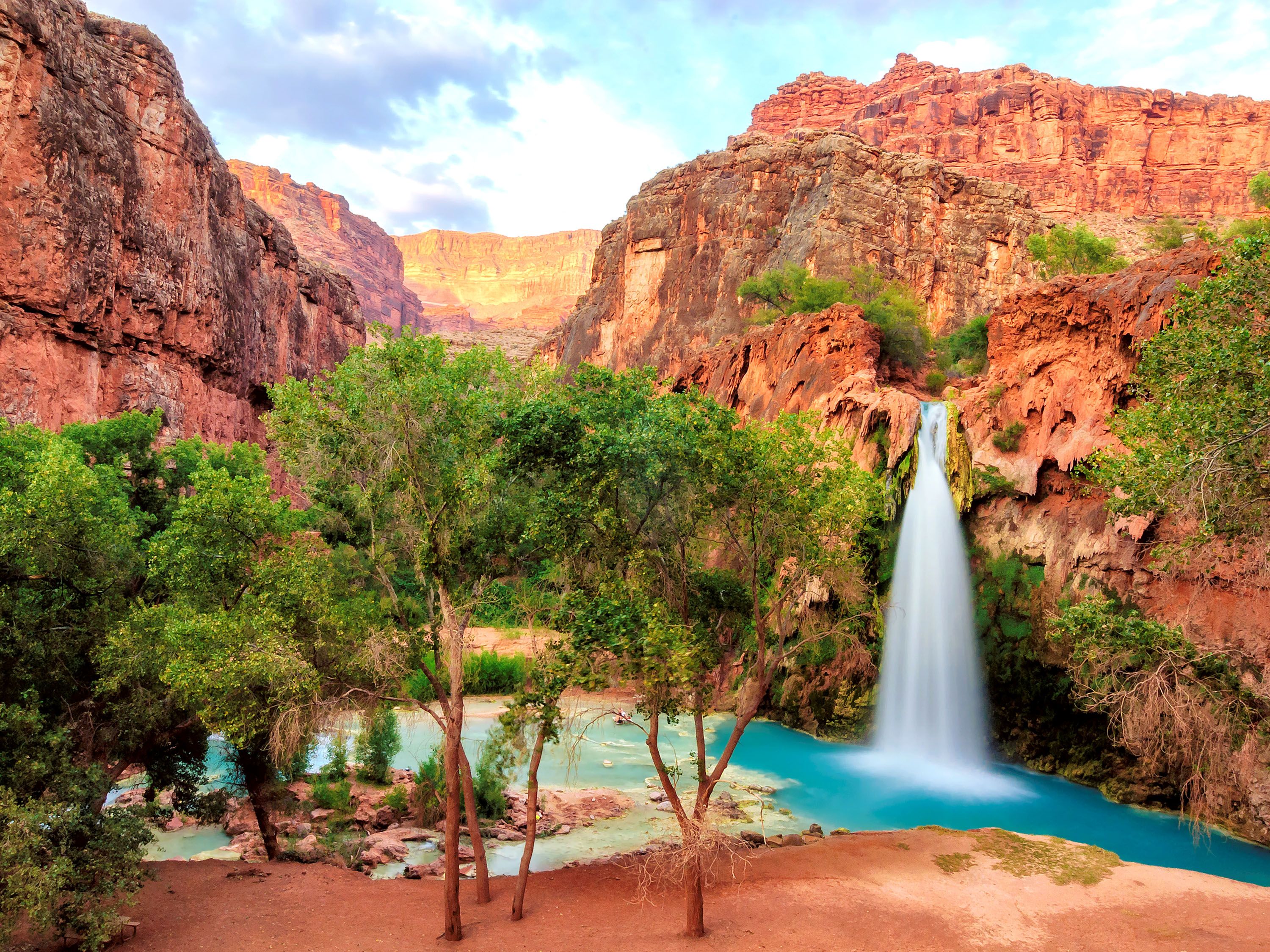 Trees and waterfall next to rock structures