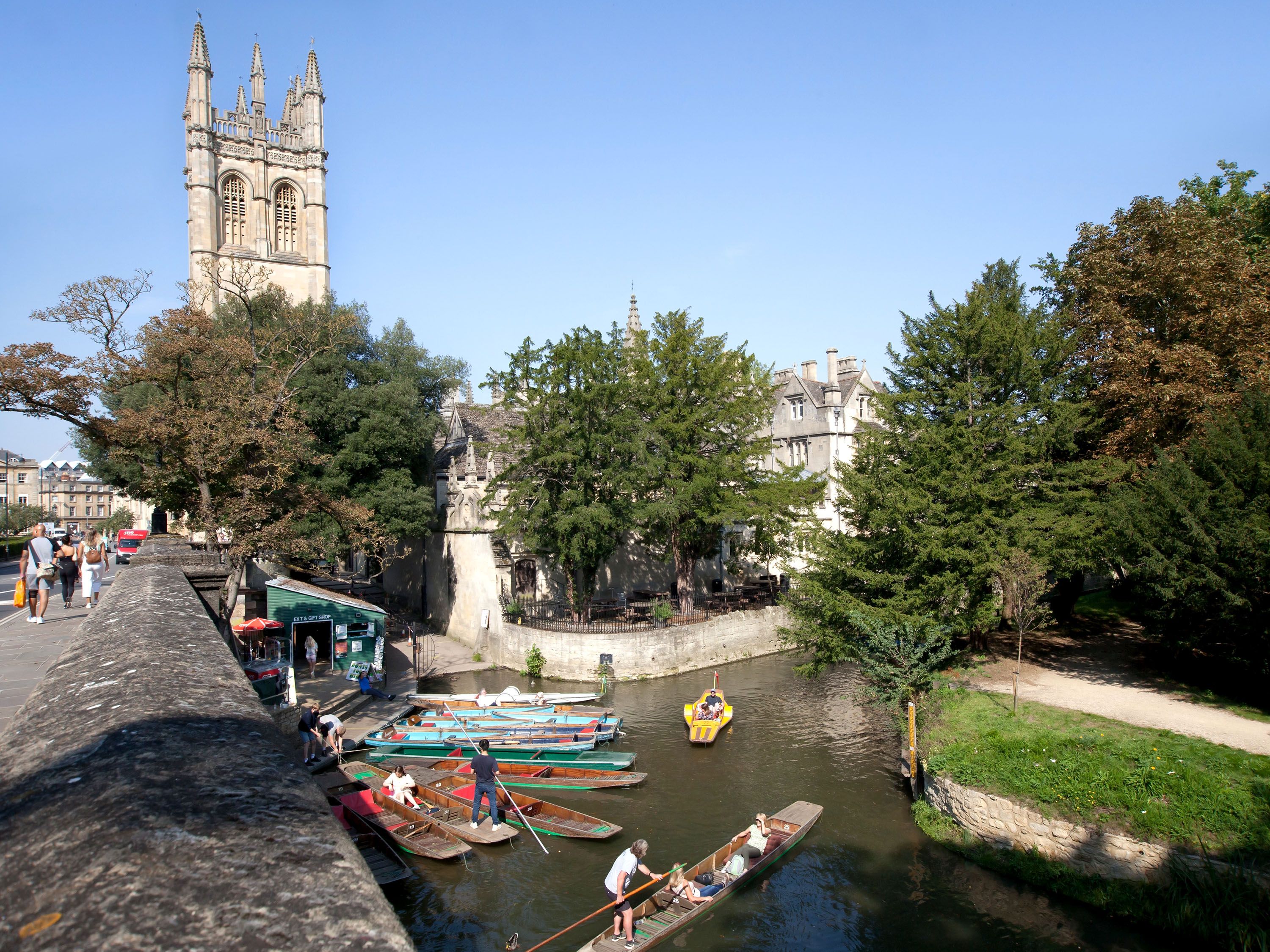 Canal with gondolas and a building with a tower.