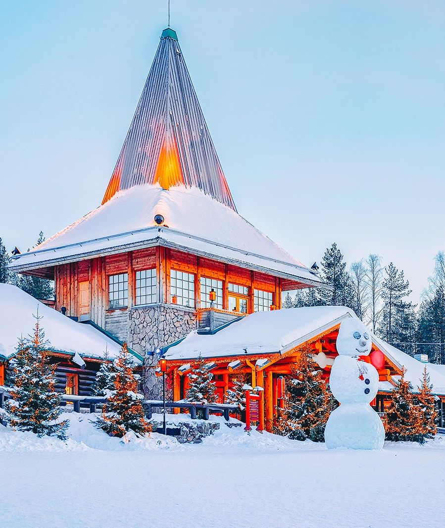 Snow-covered buildings at Santa Claus Village in Rovaniemi, Finland