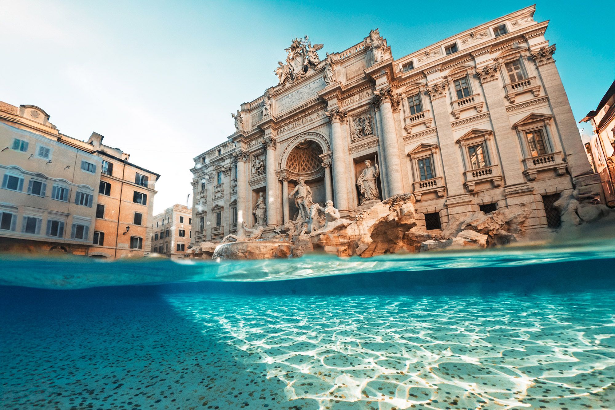 A view of the coins in the water with the Trevi Fountain in the background in Rome, Italy.