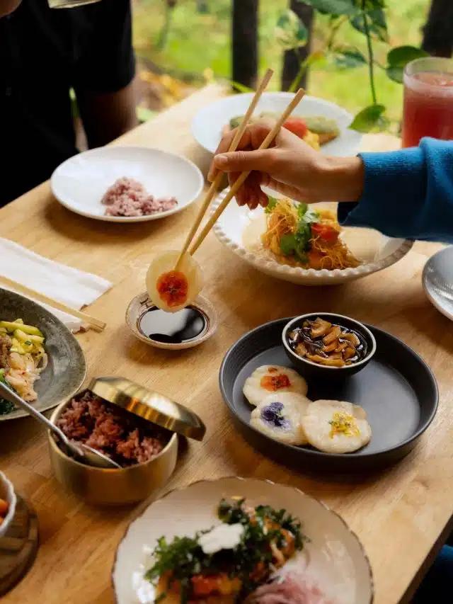 A table heaving with plates of delicious delicacies at O’Kims Korean Kitchen