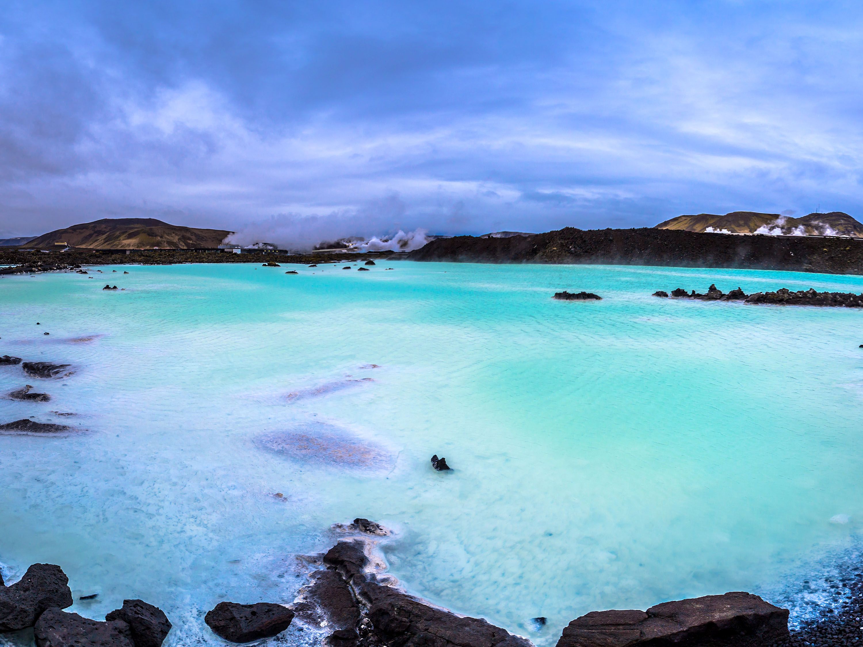 Rocky edge of bright blue water.