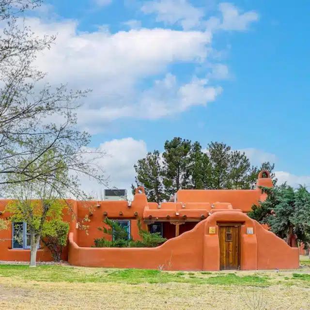 A bright orange adobe-style Vrbo in Las Cruces, New Mexico