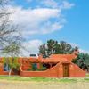 A bright orange adobe-style Vrbo in Las Cruces, New Mexico