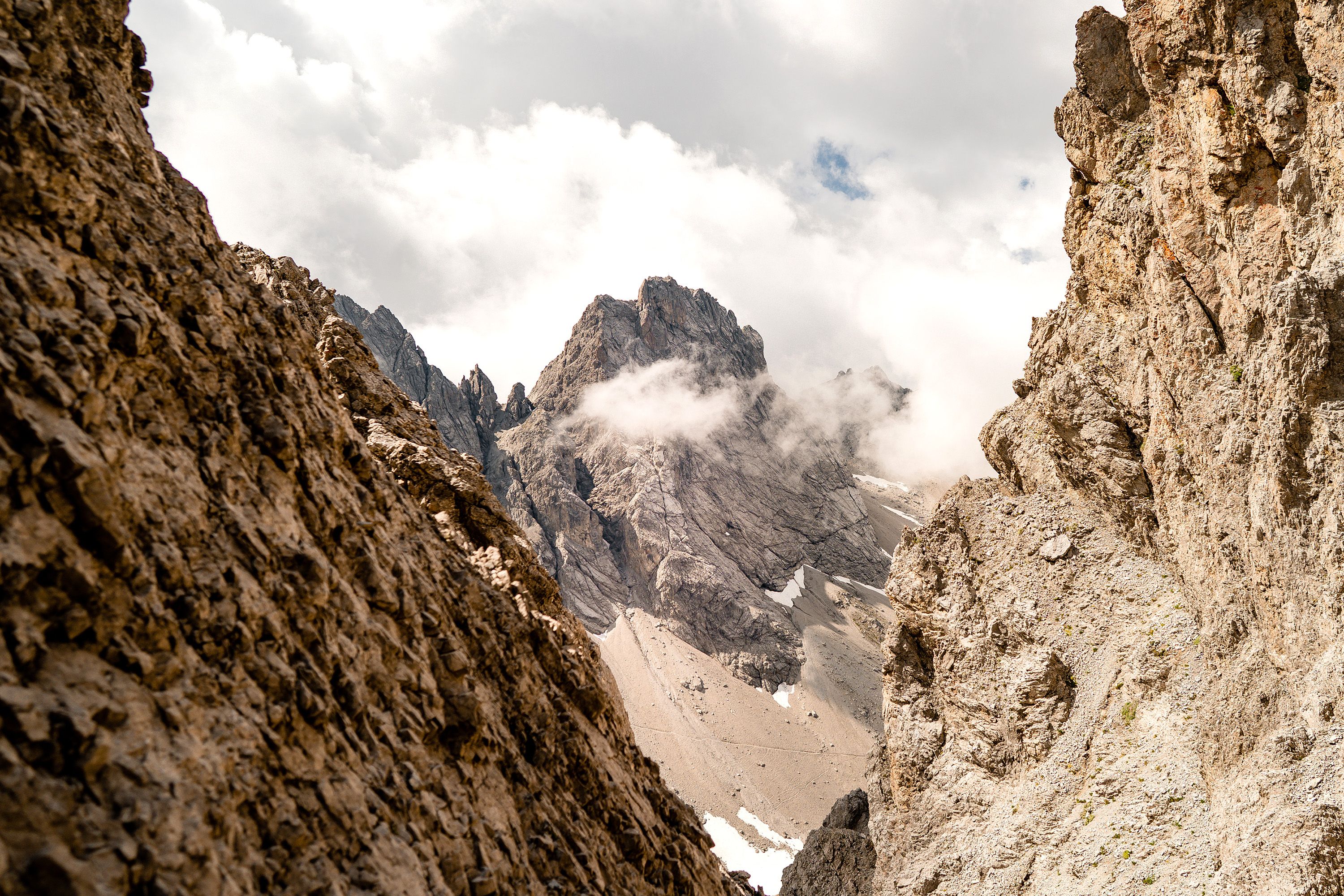 Clouds scatter among mountain peaks.