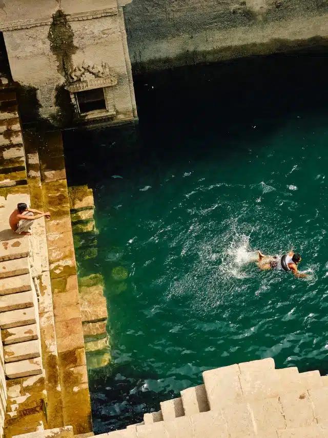 Swimmers in the Toorji Ka Jhalra stepwell in Jodphur, India