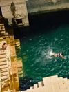 Swimmers in the Toorji Ka Jhalra stepwell in Jodphur, India