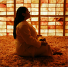 A woman sits cross-legged in a salt chamber at Spa L.A.
