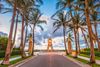 Palm-lined walkway leading to Worth Avenue Clock Tower in Palm Beach, Florida