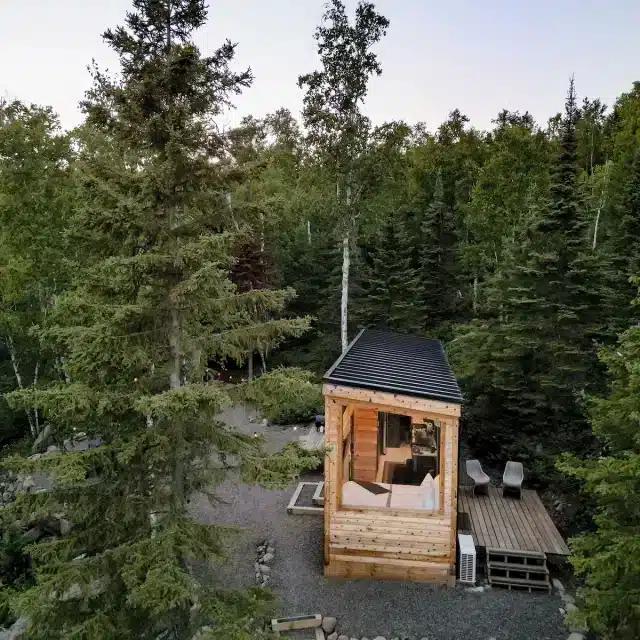A wooden cabin set among tall trees in Split Rock Lighthouse State Park