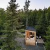 A wooden cabin set among tall trees in Split Rock Lighthouse State Park