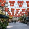 Larimer Street in Denver, Colorado, is decorated with strings of sports jerseys and lights overhead