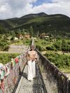 Jessica Nabongo walks across the suspension bridge in Punakha, Bhutan