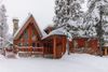 Snow-covered A-frame cabin in East Kootenay, listed on Vrbo for a cozy ski getaway.