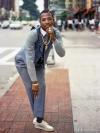 An image of a man in a grey waistcoat, white-collared grey shirt, grey pinstripe pants and gold jewelry, from A Time Before Crack, by Jamel Shabazz (powerHouse Books)