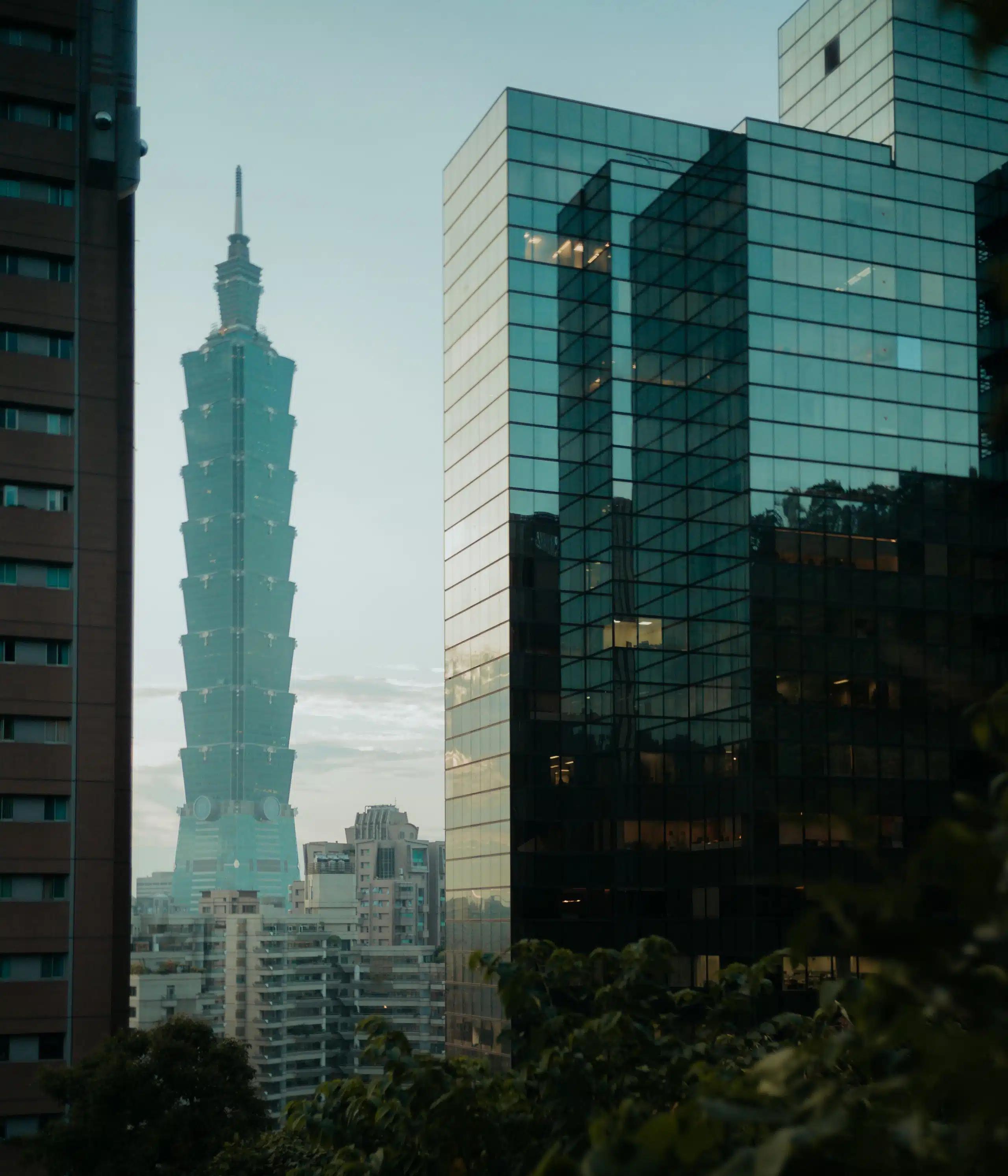 The sculptural lines of Taipei 101, seem through a ravine of glass-sided skyscrapers