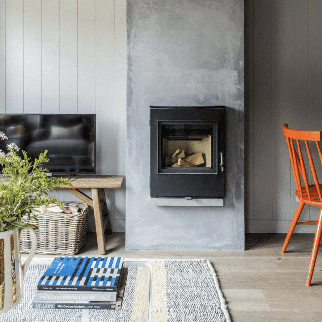 A log burner in a modern living room of a Vrbo in Somerset