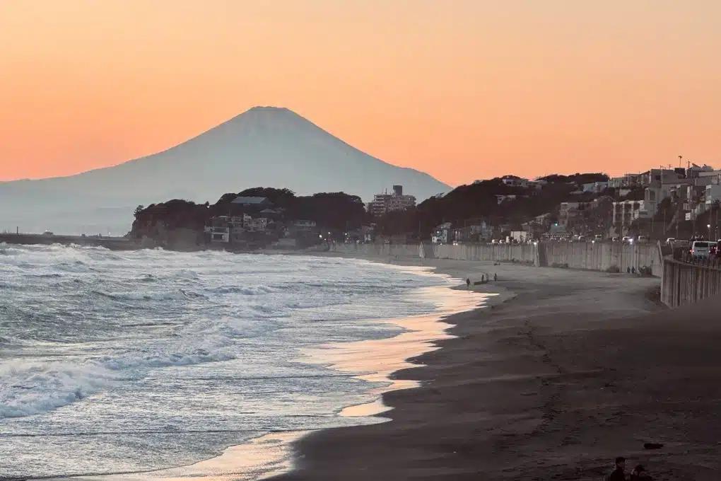 Kamakura's Shichirigahama Beach at sunset, with Mount Fuji's silhouette visible in the background
