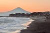 Kamakura's Shichirigahama Beach at sunset, with Mount Fuji's silhouette visible in the background