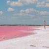 A person stands beside the pink lagoons in Mexico