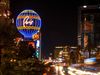Paris Las Vegas sign at night with cars speeding by.